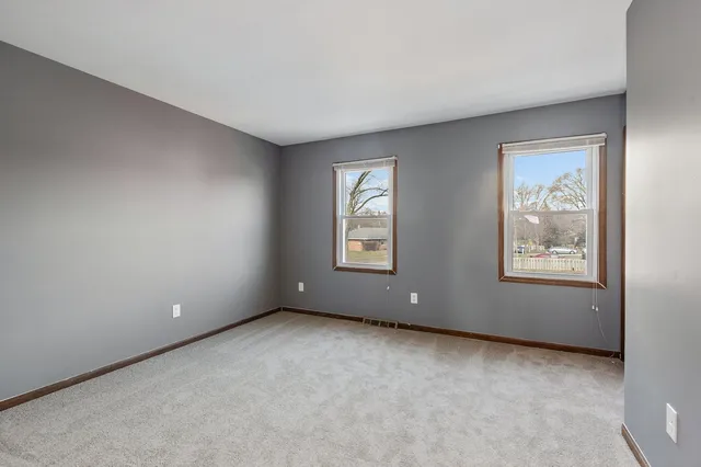 a view of an empty room with windows