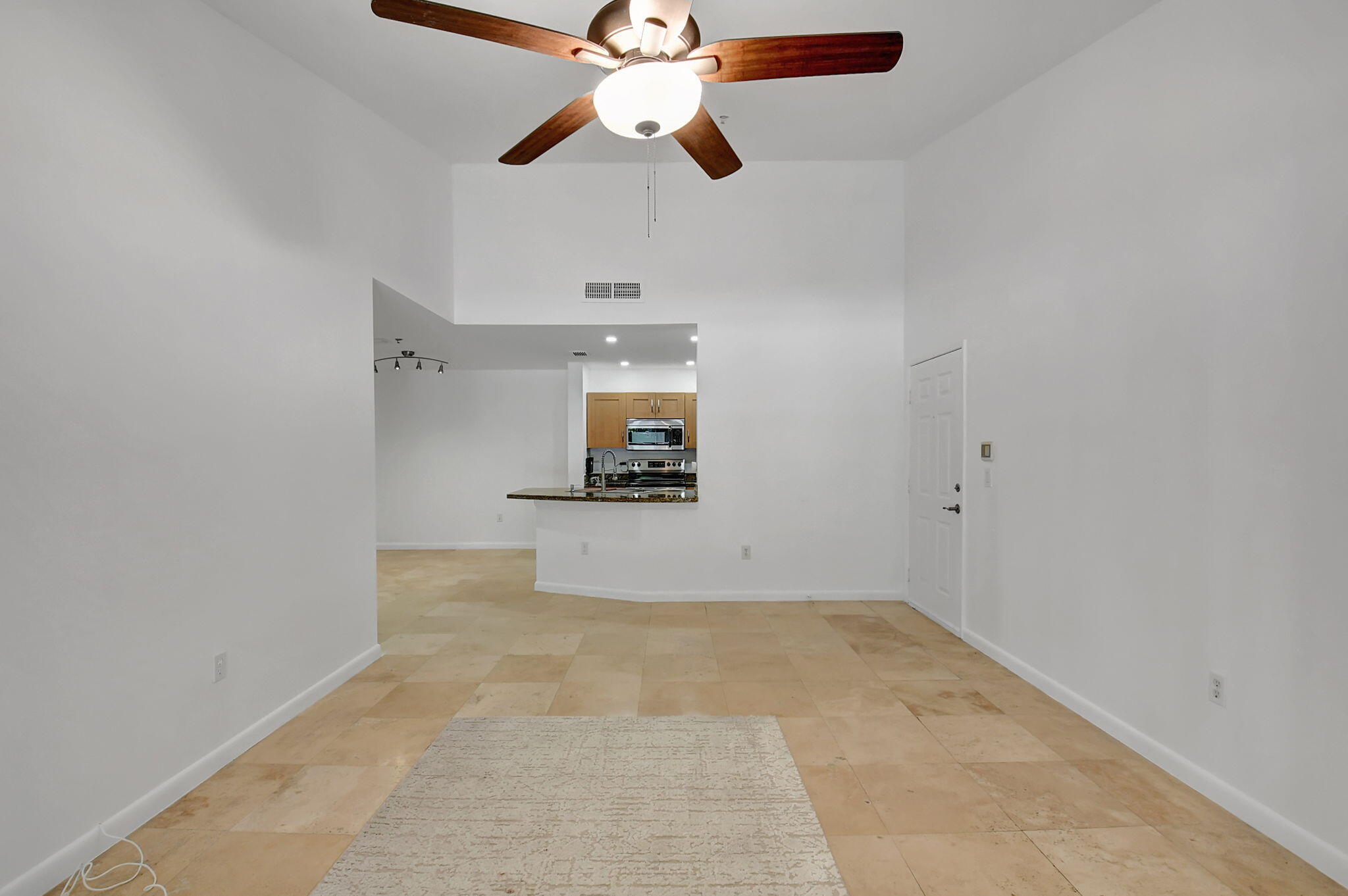 3207 Clint Moore Road, Unit 206 Boca Raton, FL 33496 - Photo 16 of 54 en empty room with ceiling fan and window