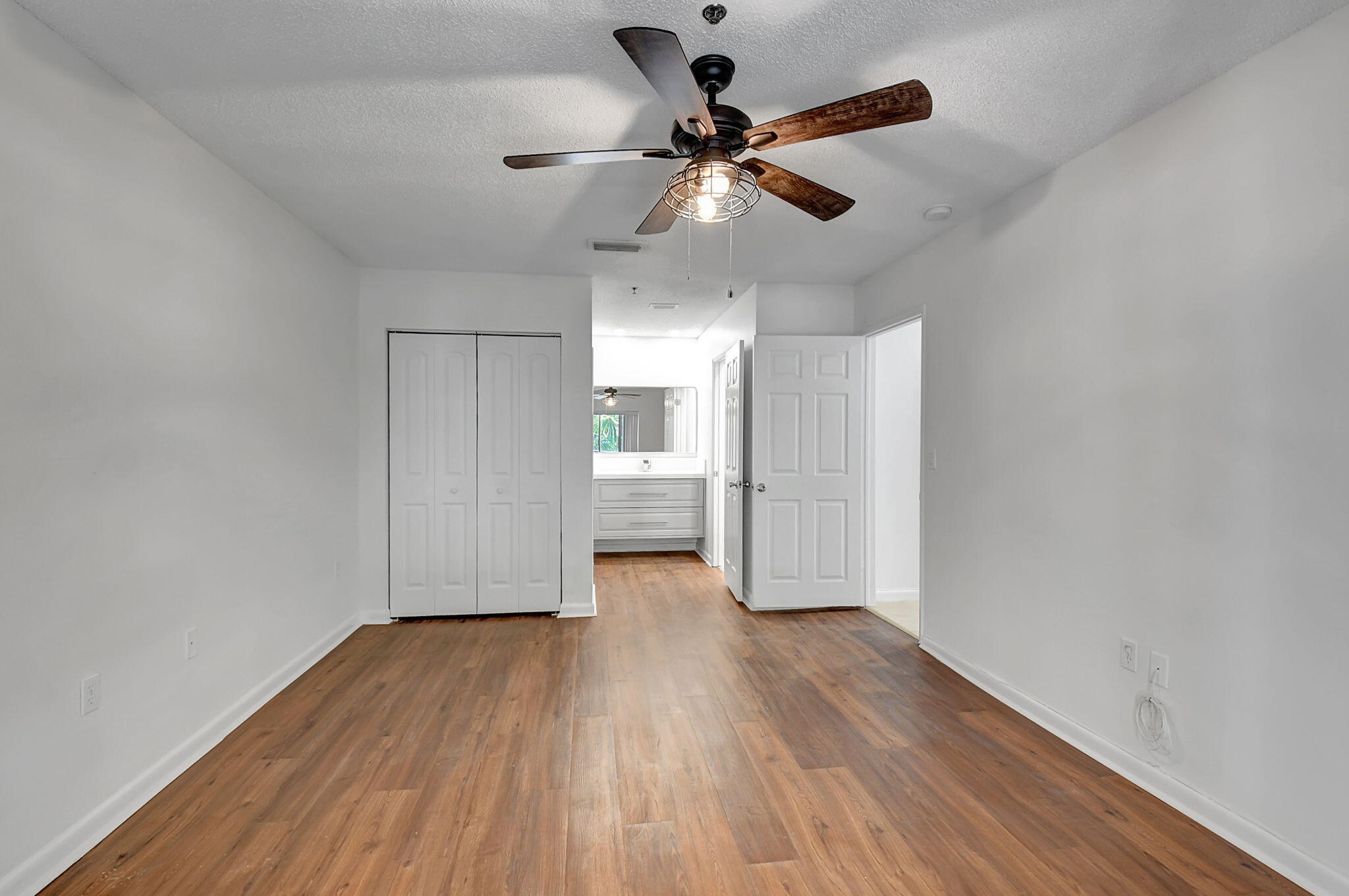 3207 Clint Moore Road, Unit 206 Boca Raton, FL 33496 - Photo 28 of 54 a view of empty room with wooden floor