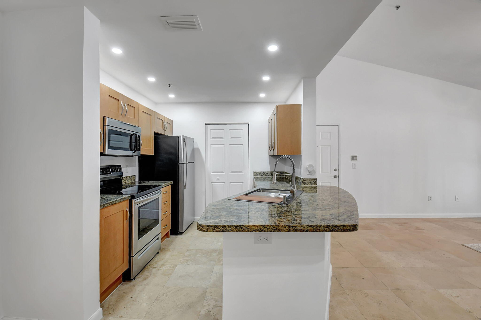 3207 Clint Moore Road, Unit 206 Boca Raton, FL 33496 - Photo 5 of 54 a kitchen with stainless steel appliances granite countertop a sink stove and refrigerator