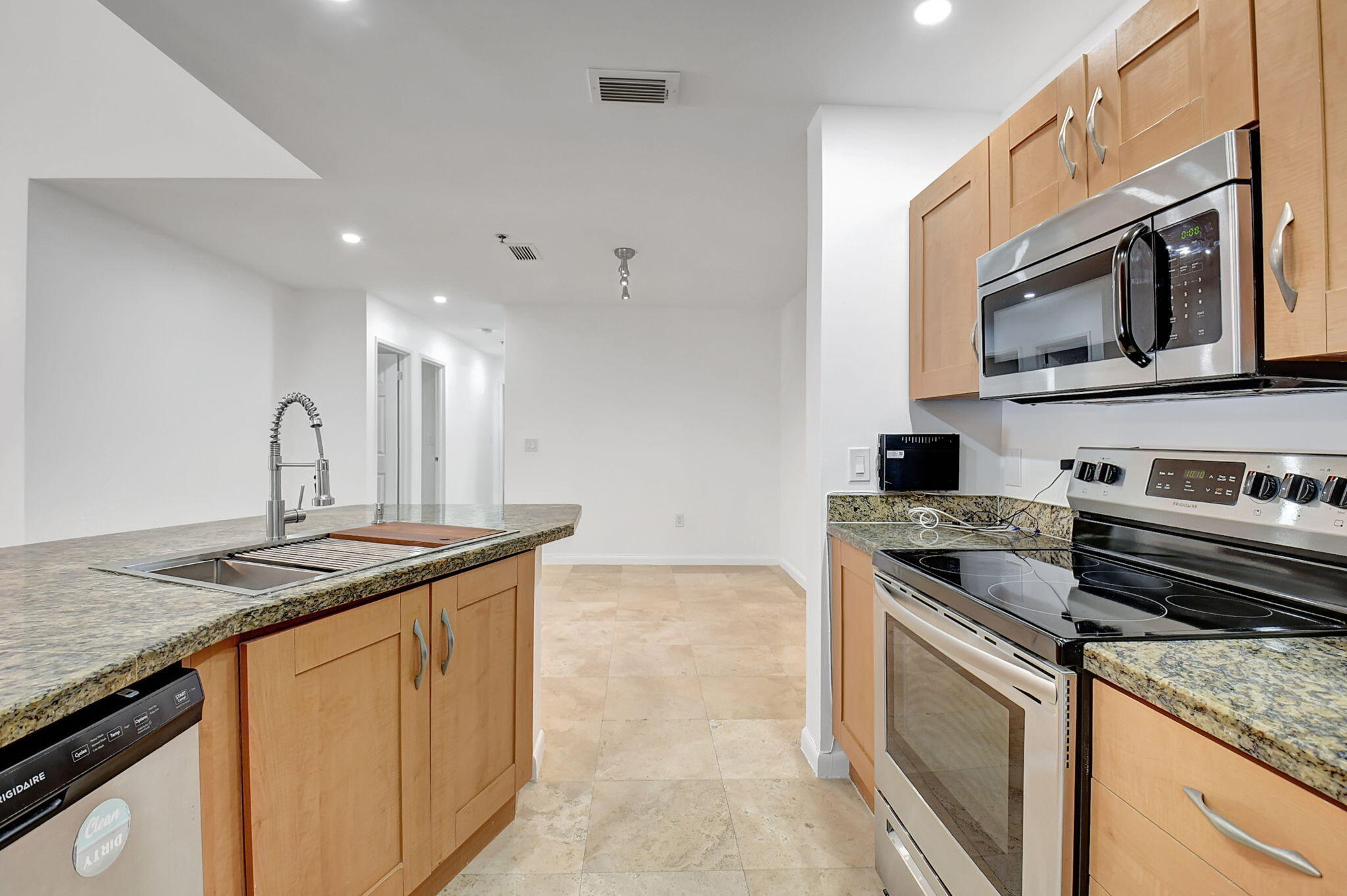 3207 Clint Moore Road, Unit 206 Boca Raton, FL 33496 - Photo 9 of 54 a kitchen with granite countertop a stove sink and microwave