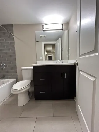 a bathroom with a toilet and bathtub