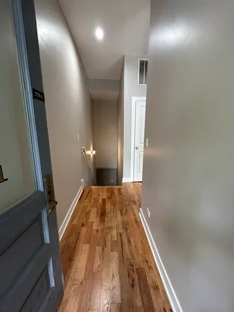 a view of hallway with wooden floor