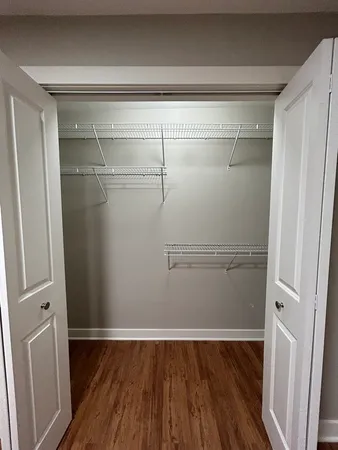 a view of a room with wooden floor