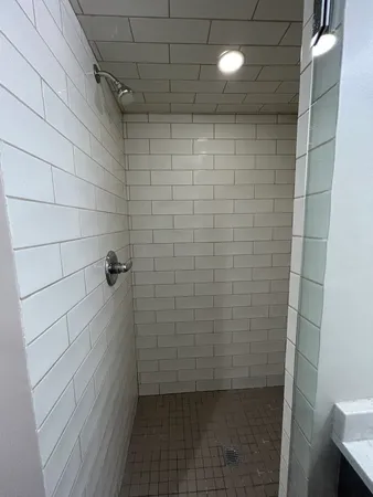 a picture of a bathroom with a white wall and a picture