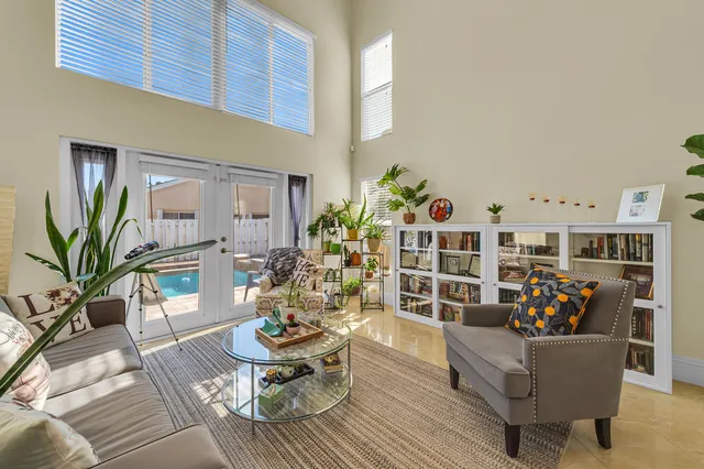 a living room with furniture stairs and a potted plant