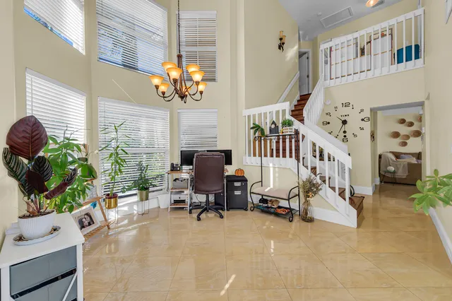a living room filled with furniture hardwood floor and a chandelier