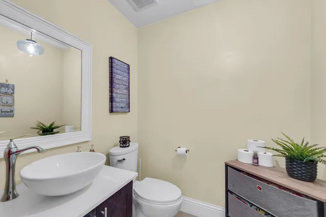 a bathroom with a toilet a sink and mirror