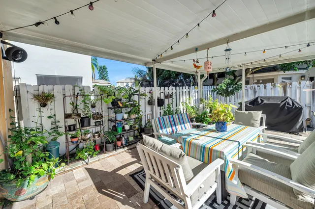 a view of a patio with table and chairs potted plants