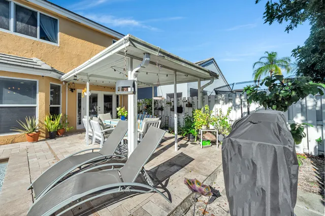 a view of a house with swimming pool and sitting area