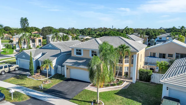 a aerial view of a house with swimming pool garden and patio