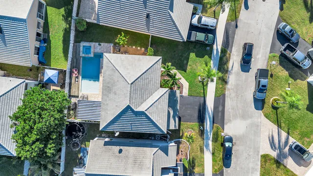 an aerial view of a house with garden space and street view