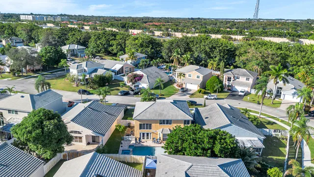 an aerial view of residential houses with outdoor space and street view