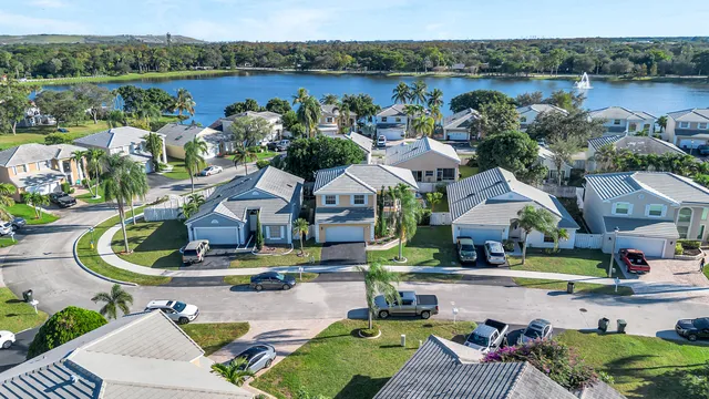an aerial view of a house with outdoor space and lake view
