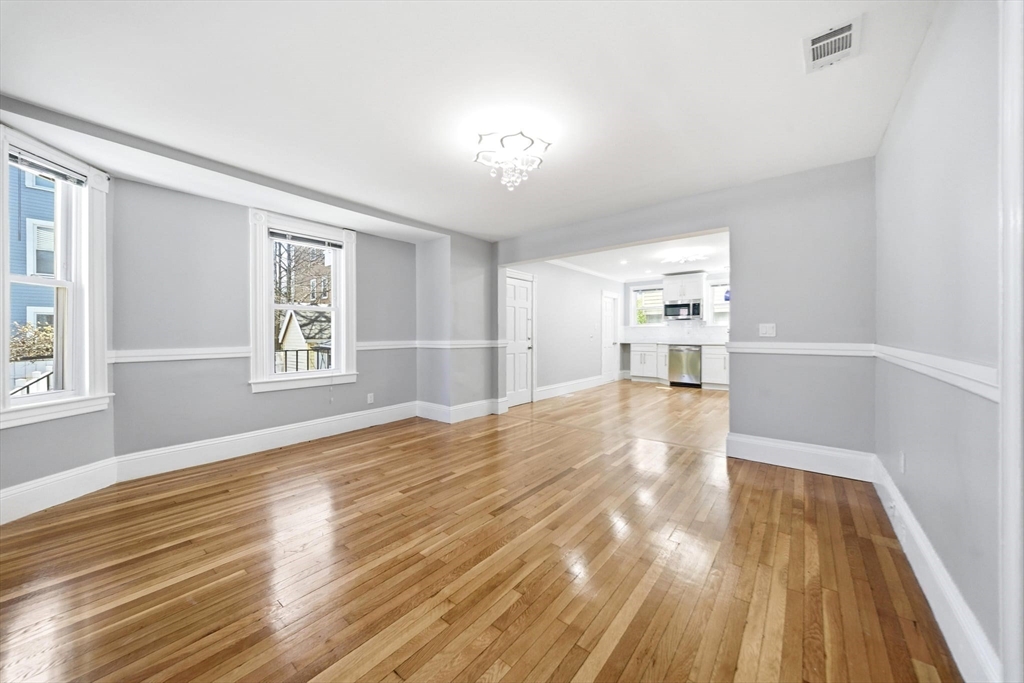 29 Hanson Street, Unit 1 Somerville, MA 02143 - Photo 12 of 40 a view of empty room with wooden floor and fan