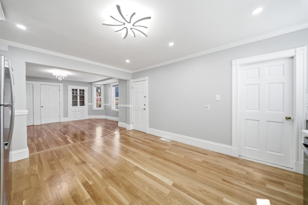 29 Hanson Street, Unit 1 Somerville, MA 02143 - Photo 22 of 40 a view of empty room with wooden floor and fan