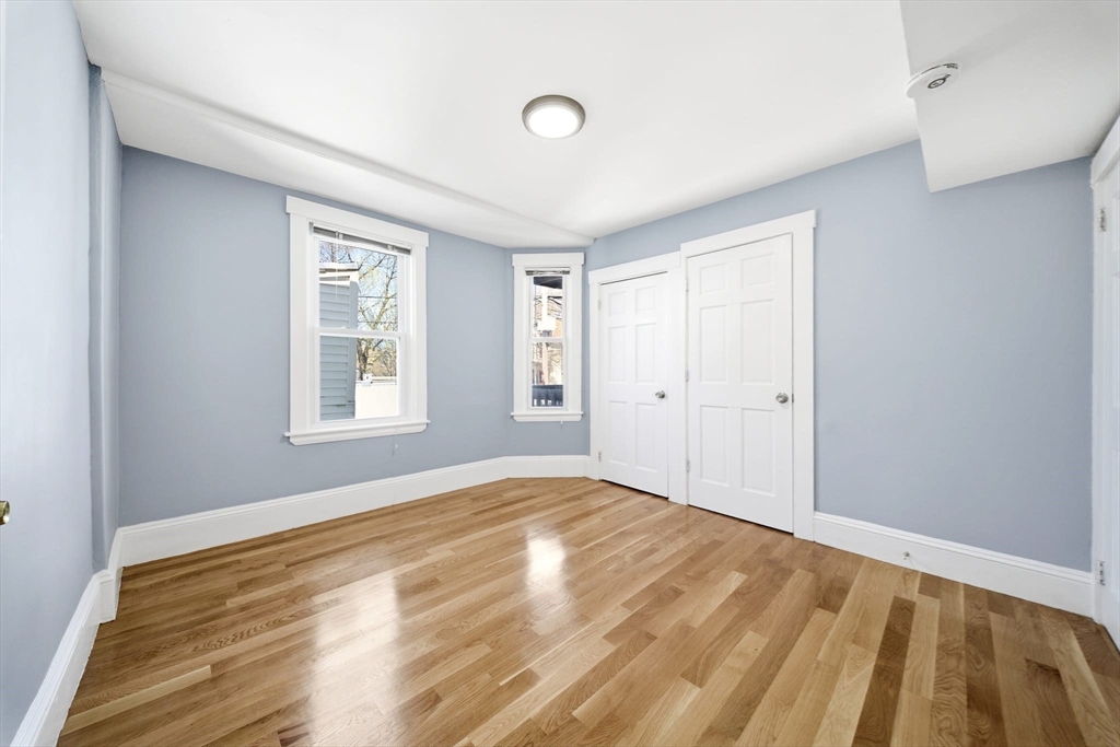 29 Hanson Street, Unit 1 Somerville, MA 02143 - Photo 25 of 40 a view of empty room with wooden floor and fan
