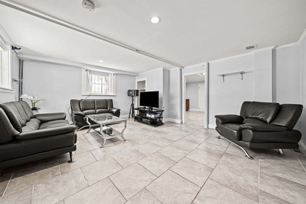 29 Hanson Street, Unit 1 Somerville, MA 02143 - Photo 30 of 40 a living room with furniture and a flat screen tv