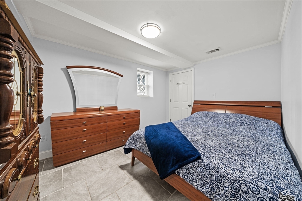 29 Hanson Street, Unit 1 Somerville, MA 02143 - Photo 33 of 40 a bedroom with a bed and a dresser