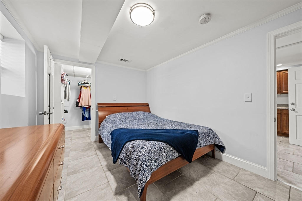 29 Hanson Street, Unit 1 Somerville, MA 02143 - Photo 34 of 40 a bedroom with a bed and wooden floor