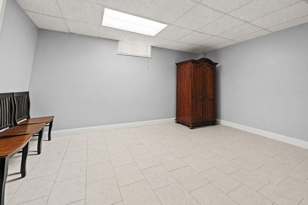 29 Hanson Street, Unit 1 Somerville, MA 02143 - Photo 35 of 40 a view of an empty room with wooden floor and a window