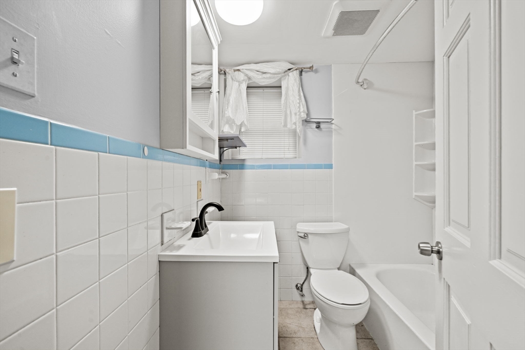 29 Hanson Street, Unit 1 Somerville, MA 02143 - Photo 36 of 40 a bathroom with a toilet sink and mirror