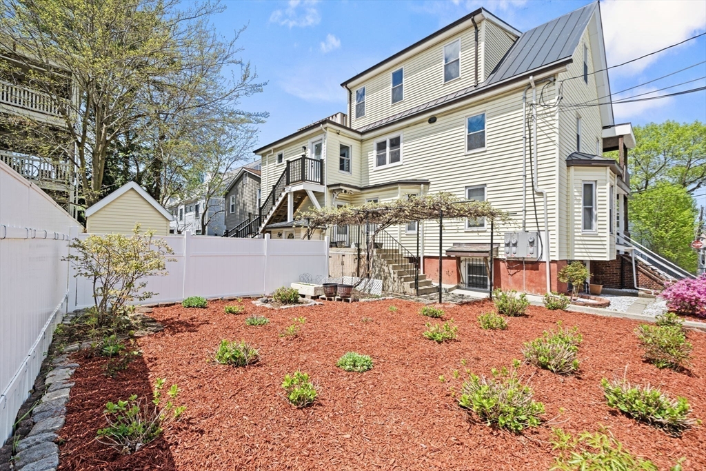 29 Hanson Street, Unit 1 Somerville, MA 02143 - Photo 6 of 40 a view of a white house with a yard