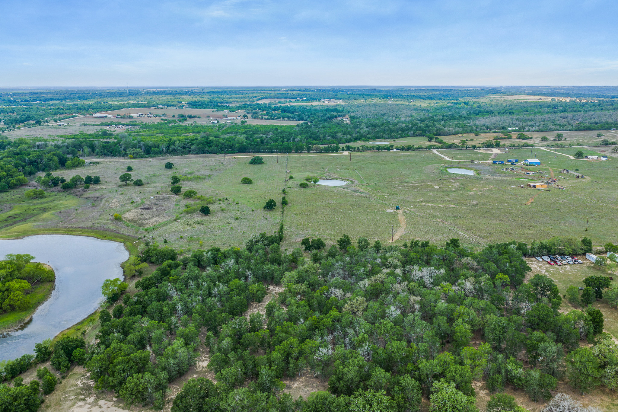 Tbd Lot 30 Tbd Road Lockhart, TX 78644 - Photo 6 of 6 Vast, verdant acreage with tranquil ponds and dense tree lines offers endless possibilities.