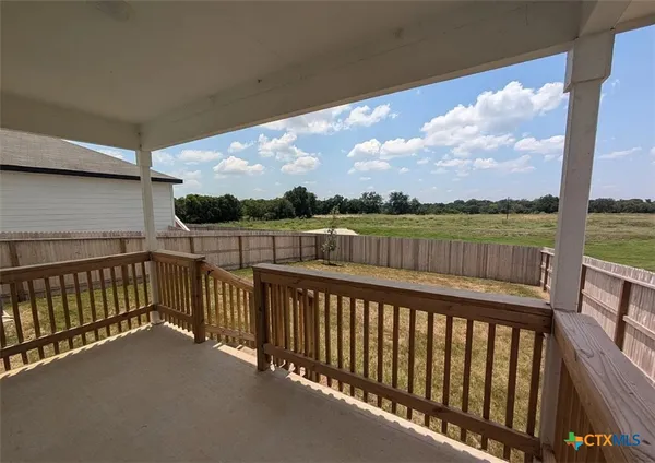 a view of a kitchen with wooden floor and staircase