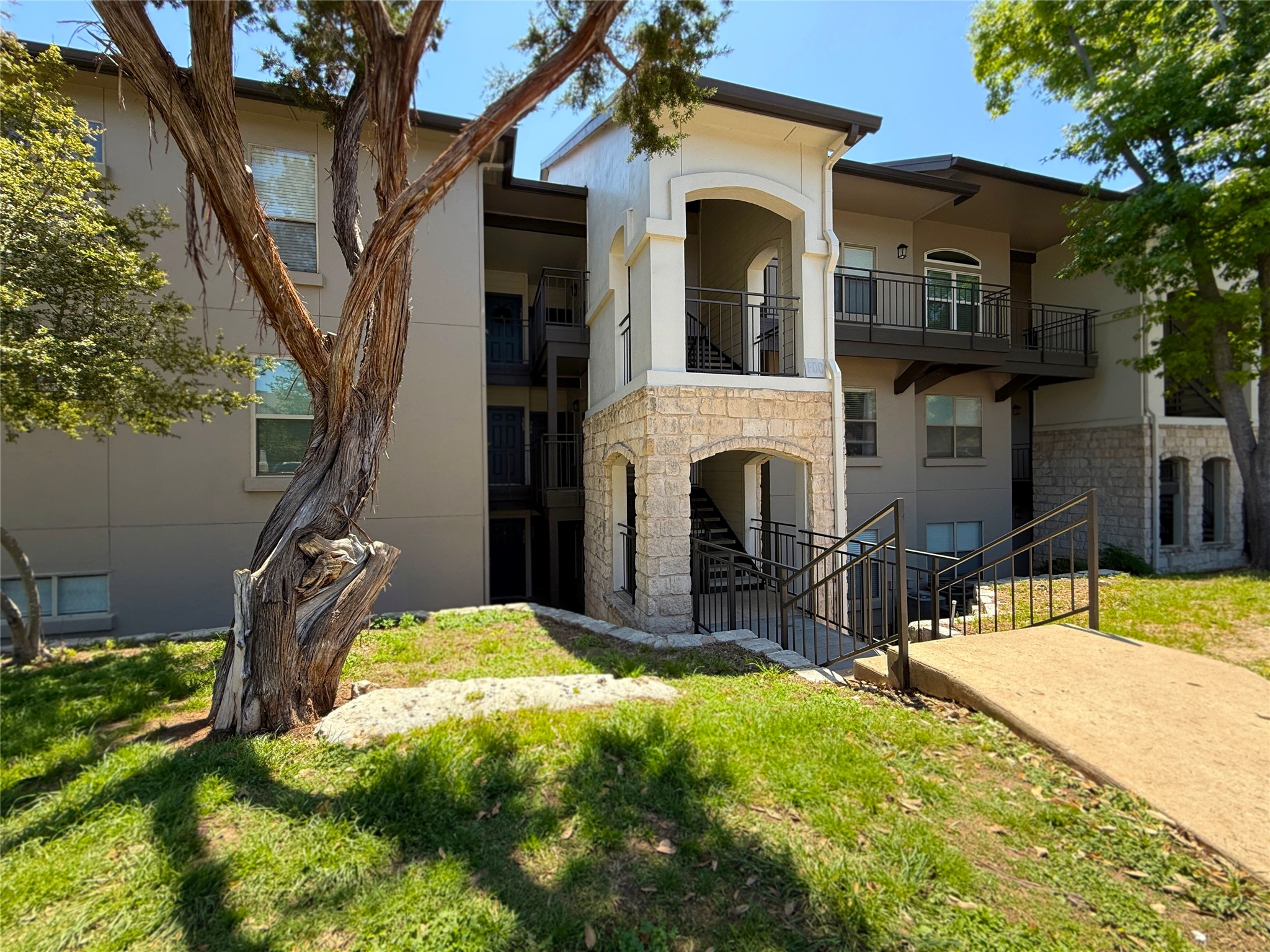 6000 Shepherd Mountain Cove, Unit 302 Austin, TX 78730 - Photo 1 of 22 a view of a house with yard and sitting area