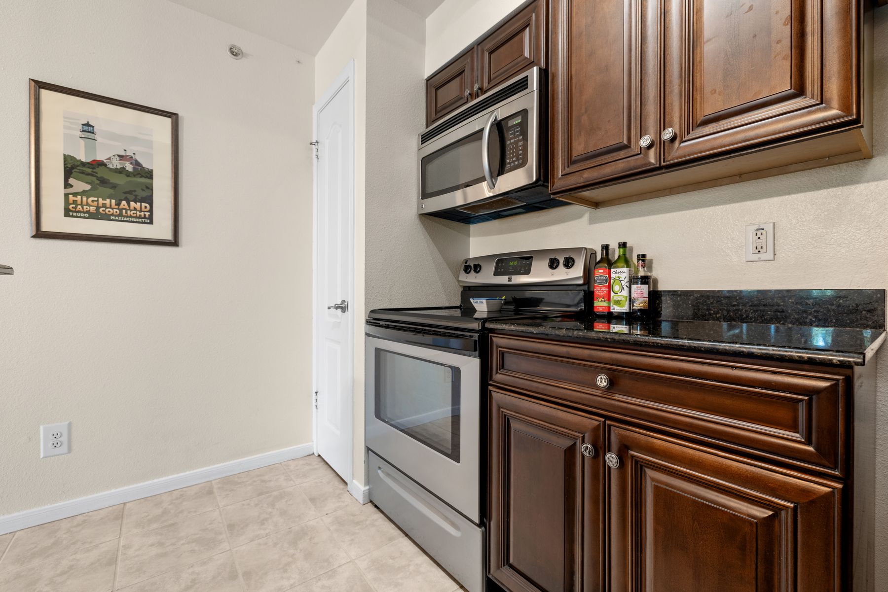 6000 Shepherd Mountain Cove, Unit 302 Austin, TX 78730 - Photo 12 of 22 a kitchen with stainless steel appliances granite countertop a refrigerator and a stove