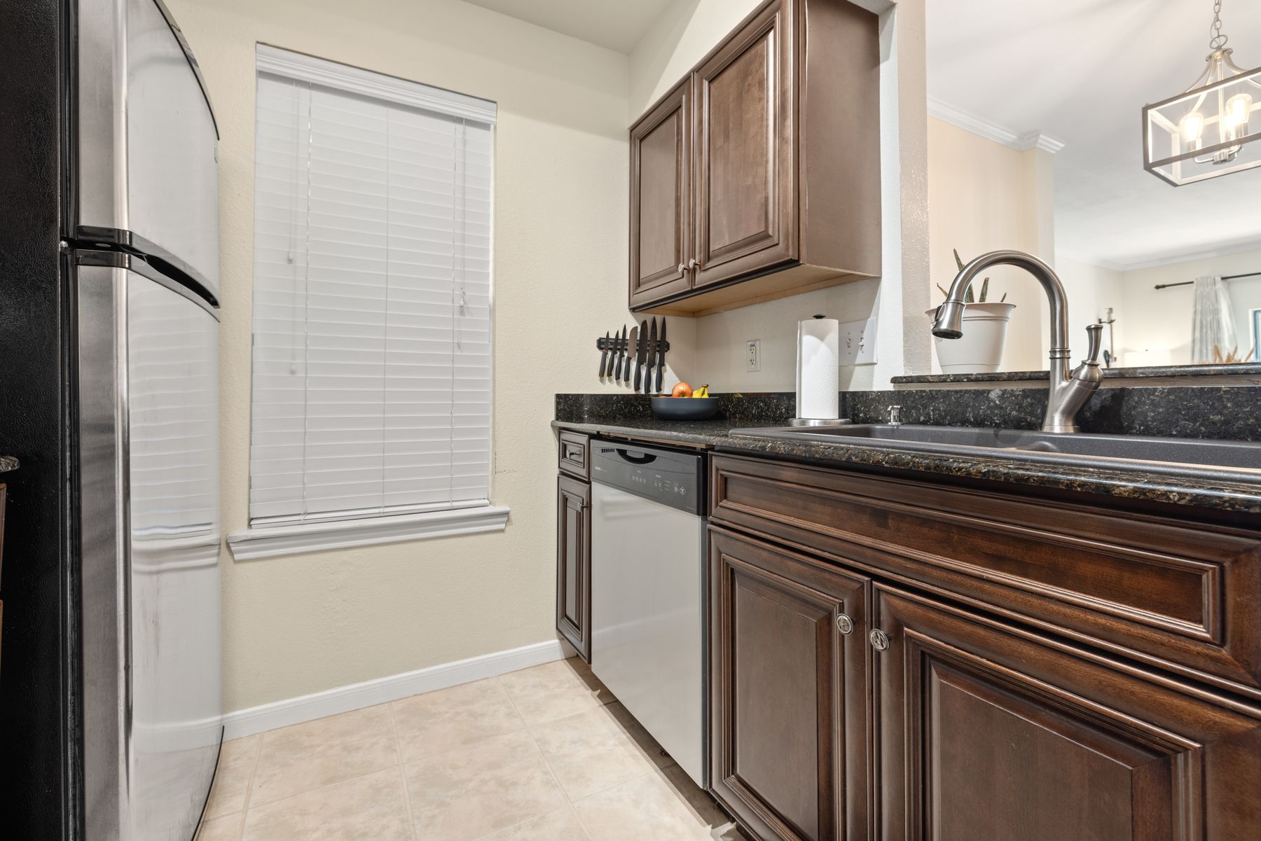 6000 Shepherd Mountain Cove, Unit 302 Austin, TX 78730 - Photo 13 of 22 a kitchen with granite countertop cabinets stainless steel appliances and a sink