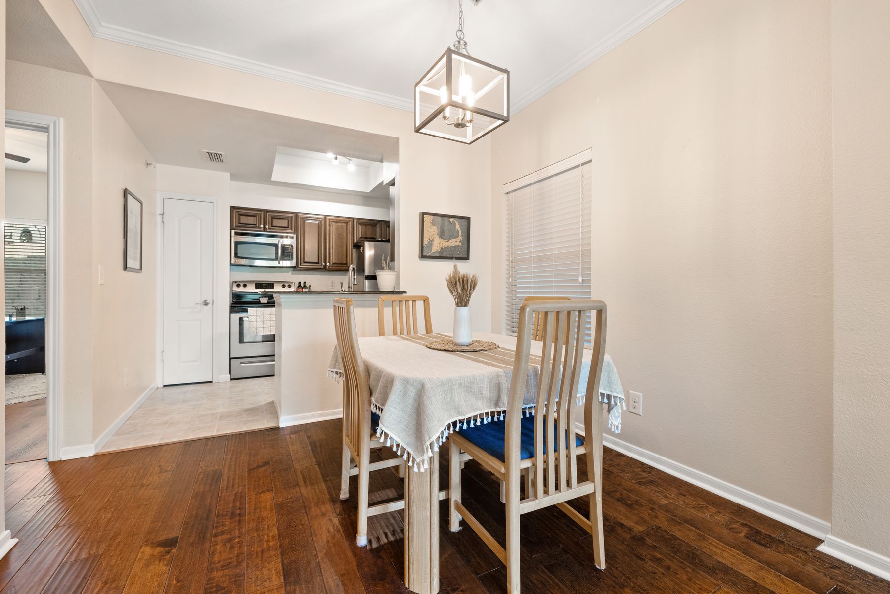 6000 Shepherd Mountain Cove, Unit 302 Austin, TX 78730 - Photo 8 of 22 a view of a dining room with furniture a chandelier and wooden floor
