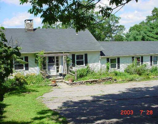 149 Bacon Road Roxbury, CT 06783 - Photo 1 of 1 a front view of a house with garden and patio