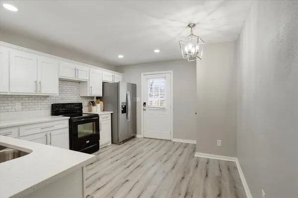 a kitchen with a refrigerator a sink and dishwasher