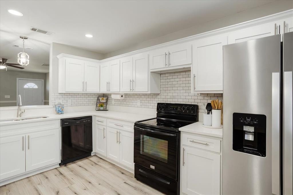 307 North Carter Street Howe, TX 75459 - Photo 16 of 31 a kitchen with white cabinets and stainless steel appliances
