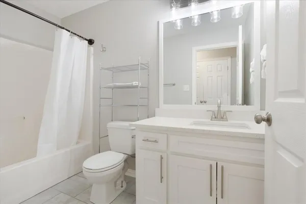 a bathroom with a sink a toilet a mirror and shower