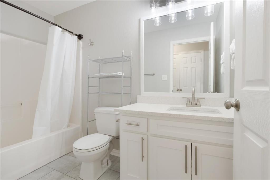 307 North Carter Street Howe, TX 75459 - Photo 24 of 31 a bathroom with a sink a toilet a mirror and shower