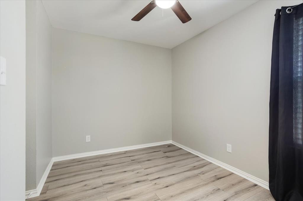 307 North Carter Street Howe, TX 75459 - Photo 26 of 31 an empty room with wooden floor and ceiling fan