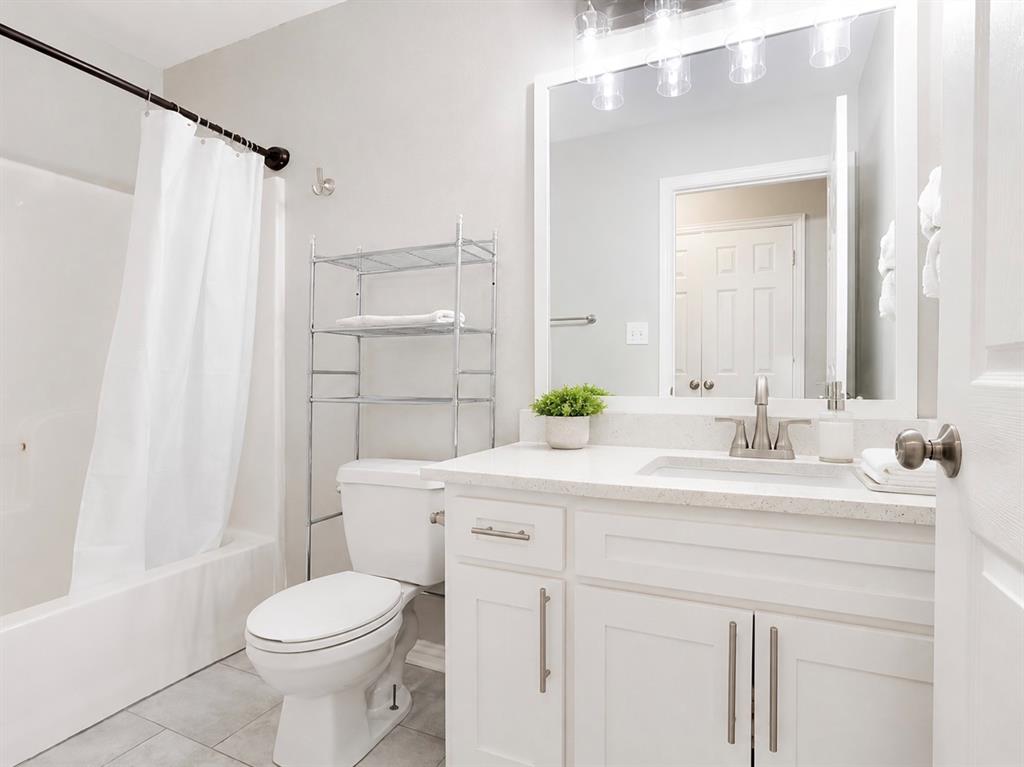 307 North Carter Street Howe, TX 75459 - Photo 7 of 31 a bathroom with a sink a toilet and shower