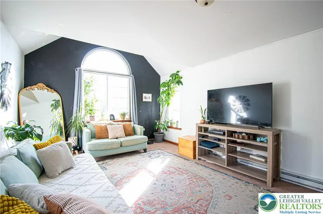 a living room with furniture and a flat screen tv