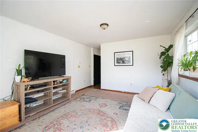 a bedroom with furniture and a flat screen tv