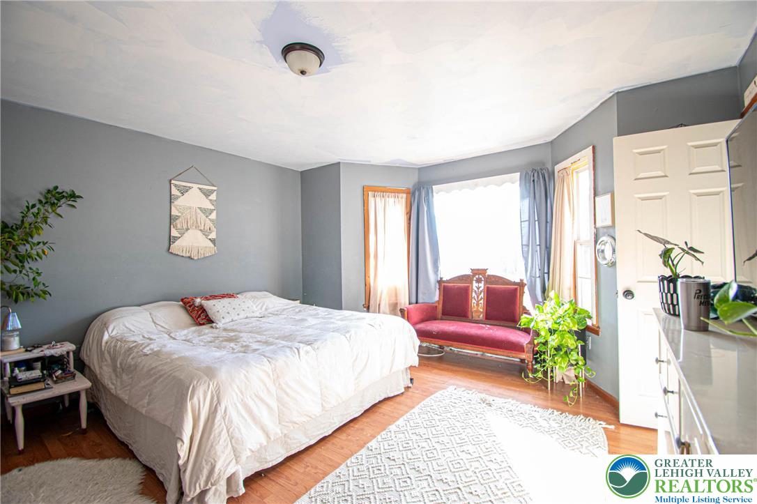 160 Grassy Road Kunkletown, PA 18058 - Photo 19 of 44 a bedroom with a bed chandelier and a window