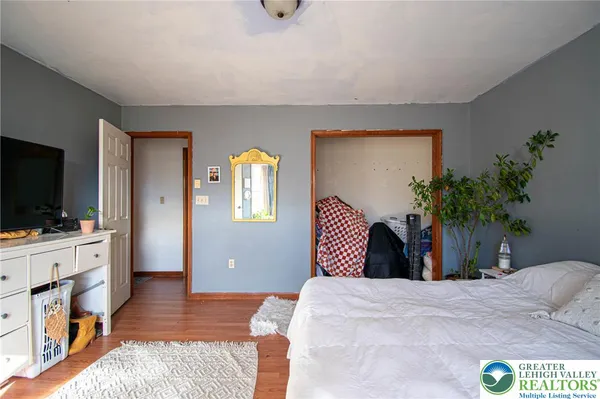 a bedroom with a bed and a flat screen tv