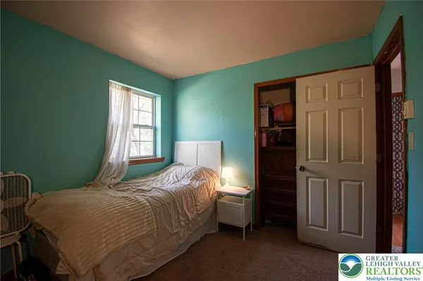 a bedroom with a bed and a window