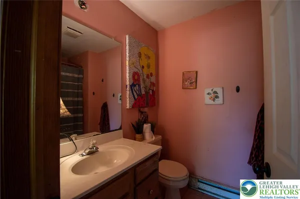 a bathroom with a sink toilet and mirror
