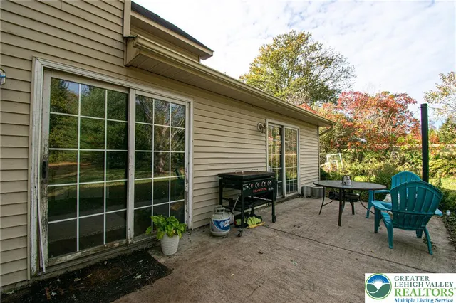 a view of a house with a chairs in patio