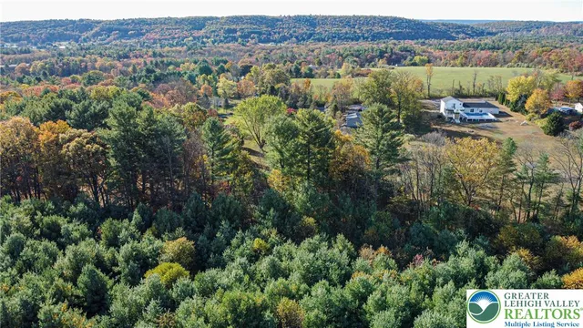 an aerial view of a house with mountain view
