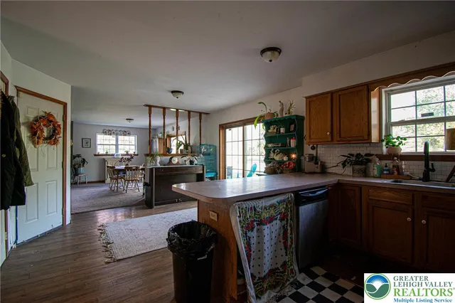 a kitchen with sink cabinets and wooden floor