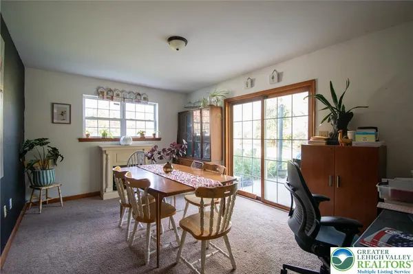 a view of a dining room with furniture and a window